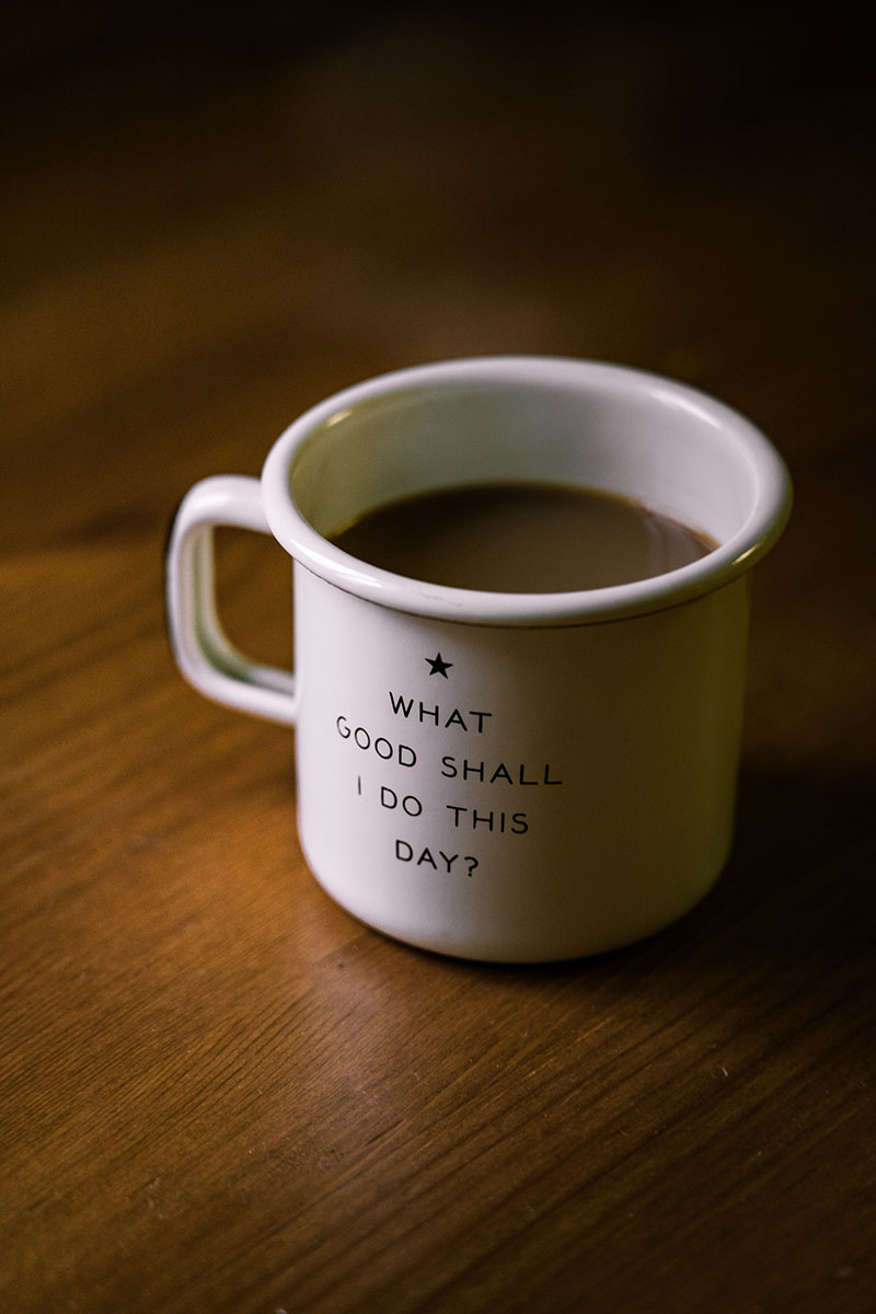 Photo of a coffee cup with the phrase "What Good Shall I do this day" on the outside